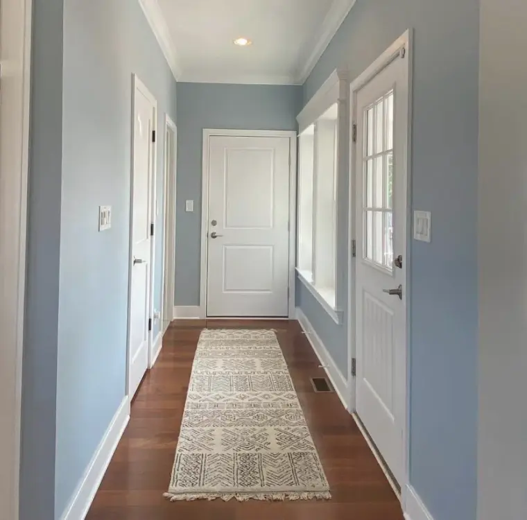 Freshly painted blue hallway with white trim