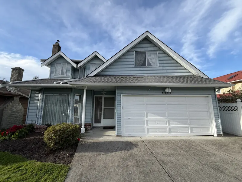 Richmond home after colour-matched trim and garage door repaint by Colour Craft Painting