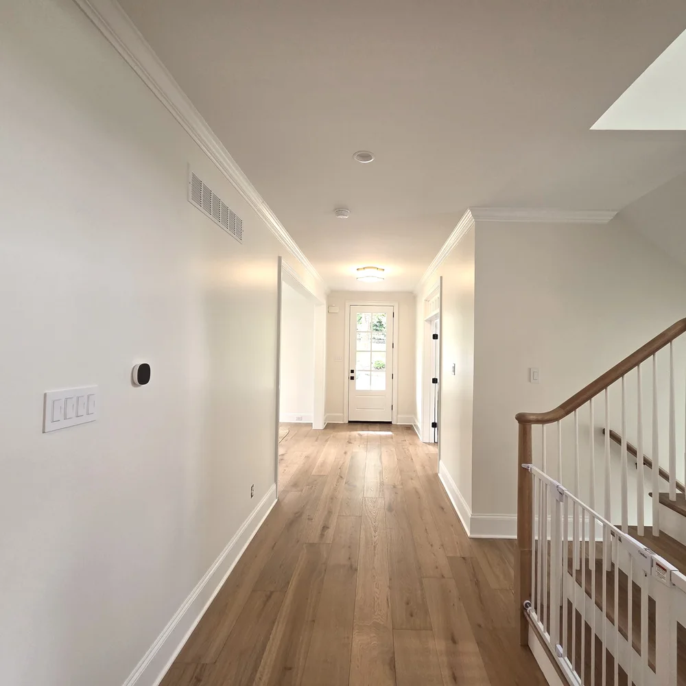 Entrance hall and stairway with a white railing after a full interior refresh by Colour Craft Painting