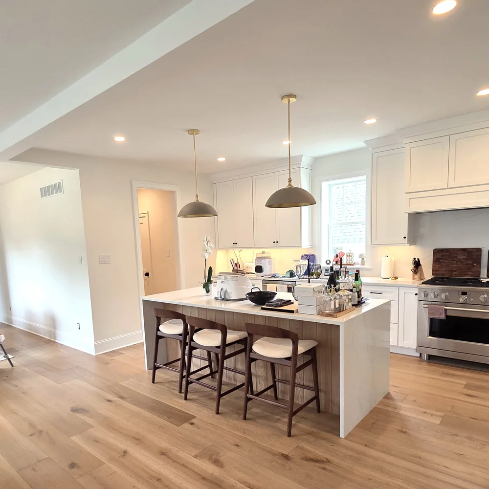 Open-plan kitchen and dining room painted white after a full interior refresh by Colour Craft Painting