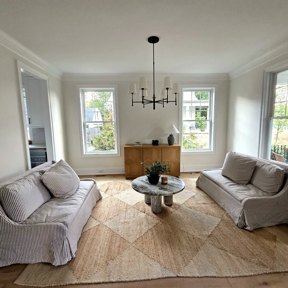 Sitting room with two windows and crown moulding after a full interior repaint by Colour Craft Painting